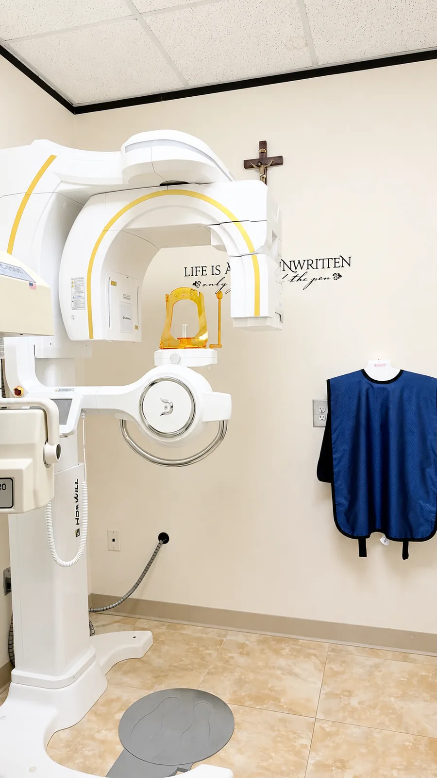 The Anatomage Cone-beam CT room at SoftDental — HDx Will scanner with lead apron and crucifix visible on the wall