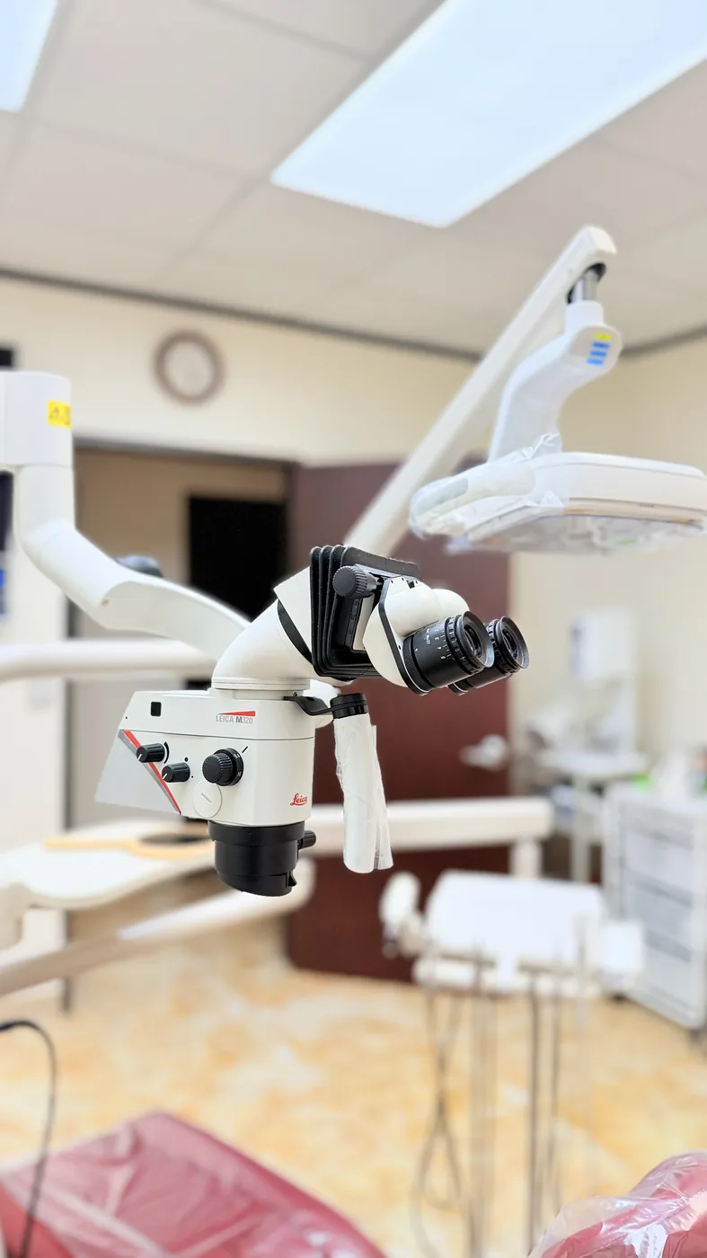 Close-up of the Leica M320 surgical microscope used at SoftDental for precision root canals and crown work